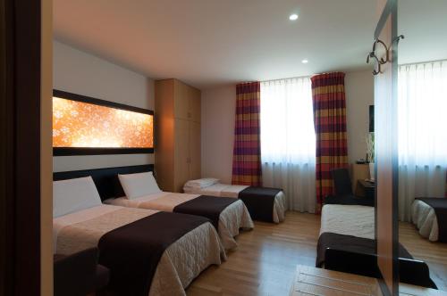 Postel nebo postele na pokoji v ubytování Sanlu Hotel