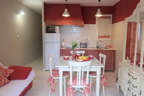 a kitchen with a table with a bowl of fruit on it at Masia Sagués in Poblet