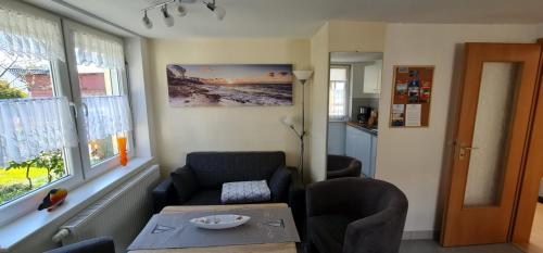 a living room with a couch and a table at Ferienhäuser Steffi und Ruth in Ueckeritz