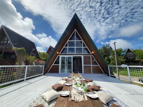 a long table on a deck in front of a house at LOGIN OKlNAWA -counrty- in Onna