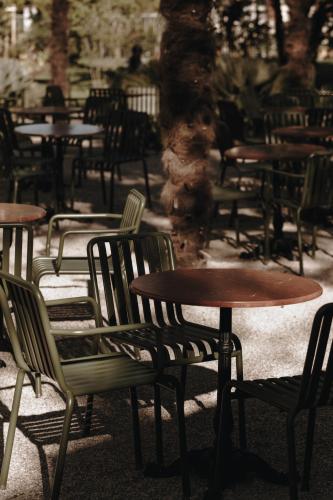 a group of tables and chairs in a restaurant at Parkhotel Mondschein, a Member of Design Hotels in Bolzano
