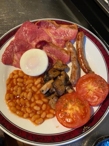 een bord voedsel met eieren spekbonen en tomaten bij Willow Tree Cottages in Newark upon Trent