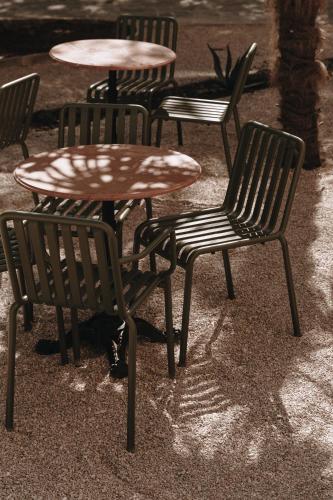 a group of chairs and tables and a table at Parkhotel Mondschein, a Member of Design Hotels in Bolzano