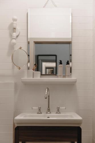 a bathroom with a sink and a mirror at Parkhotel Mondschein, a Member of Design Hotels in Bolzano