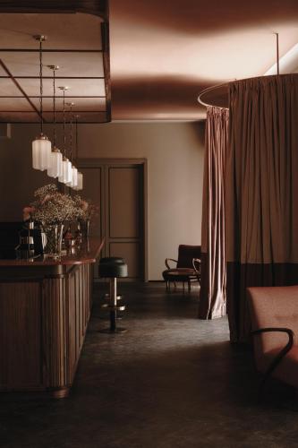 a living room with a couch and a table at Parkhotel Mondschein, a Member of Design Hotels in Bolzano