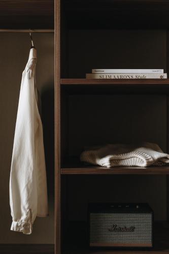 a book shelf with a white bag on it at Parkhotel Mondschein, a Member of Design Hotels in Bolzano