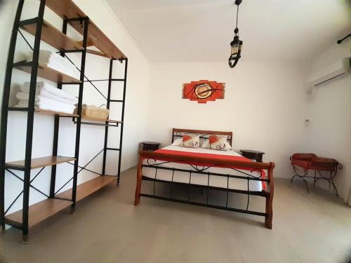 a bedroom with two bunk beds and a clock on the wall at 4 bedrooms house with furnished terrace and wifi at Trou d'Eau Douce 1 km away from the beach in Trou d'Eau Douce