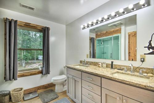 a bathroom with a sink and a toilet and a mirror at Shenandoah Valley Home - 9 Mi to Natl Park! in Front Royal