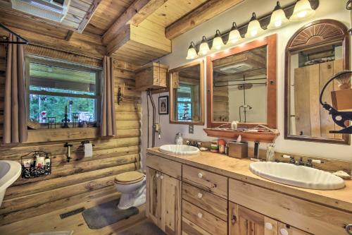 a log cabin bathroom with two sinks and a toilet at Shenandoah Valley Home - 9 Mi to Natl Park! in Front Royal