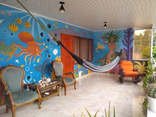 a room with an ocean themed wall with a hammock at Casa Pacha in Guaduas