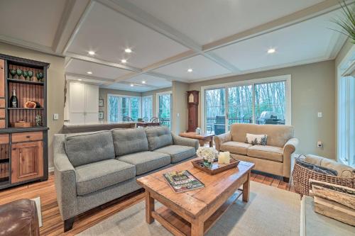 a living room with a couch and a table at Harbor Springs Retreat about 5 Mi to Downtown and Beach! in Harbor Springs
