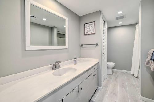 a white bathroom with a sink and a mirror at Harbor Springs Retreat about 5 Mi to Downtown and Beach! in Harbor Springs