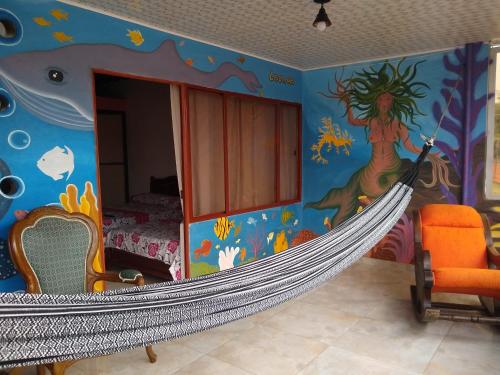a room with a bed and a hammock in it at Casa Pacha in Guaduas