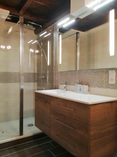 a bathroom with a sink and a shower at Chambres d'hôte des 3 Marches in Lamoura