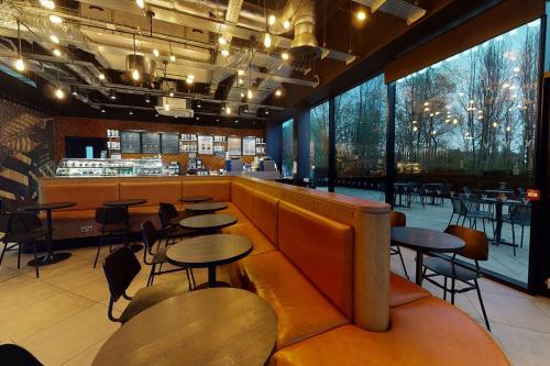 a restaurant with tables and chairs and a bar at Village Hotel Portsmouth in Portsmouth