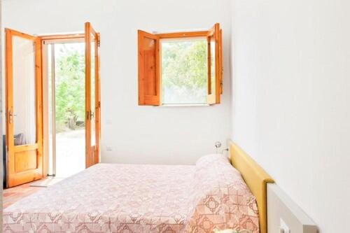 a small bedroom with a bed and a window at Borghetto Pedale in Ruvo di Puglia