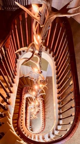 a spiral staircase with a mirror in the middle at Moffat House in Moffat