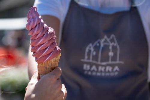 a person holding an ice cream cone in front of apron at The Lodges @ Barra Castle in Inverurie