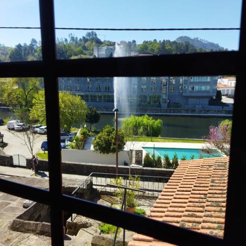 a view from a window of a building with a fountain at Casa d`Avó Ná in Termas de Sao Pedro do Sul