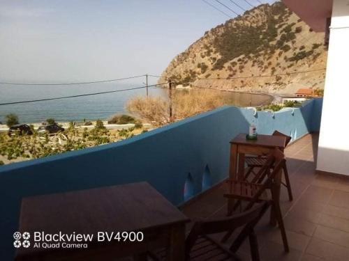 a balcony with a table and a view of the ocean at Faragi in Agia Roumeli