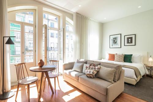 a bedroom with a bed and a couch and a bed at Porto River Infante in Porto