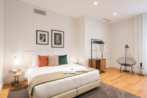 a white bedroom with a large bed in a room at Porto River Infante in Porto