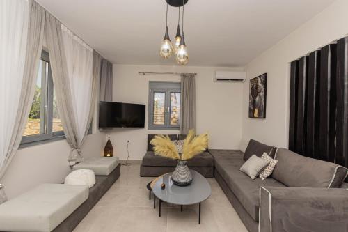 a living room with a couch and a table at Villa Di Sergio in Glinado Naxos