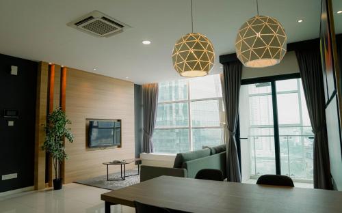 a meeting room with a table and chairs and windows at Suasana Lifestyle Suites by Keystone in Johor Bahru