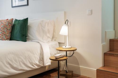 a bedroom with a bed with a lamp on a side table at Porto River Infante in Porto