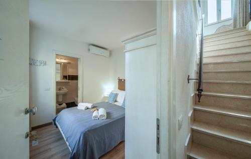 a small room with a bed and a staircase at Rocca Doria in Castelsardo