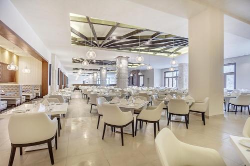 a dining room with white tables and chairs at Royalton Hideaway Saint Lucia, An Autograph Collection All-Inclusive Resort - Adults Only in Gros Islet