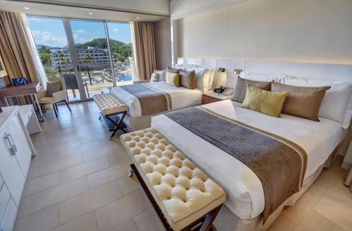 a hotel room with two beds and a large window at Royalton Hideaway Saint Lucia, An Autograph Collection All-Inclusive Resort - Adults Only in Gros Islet
