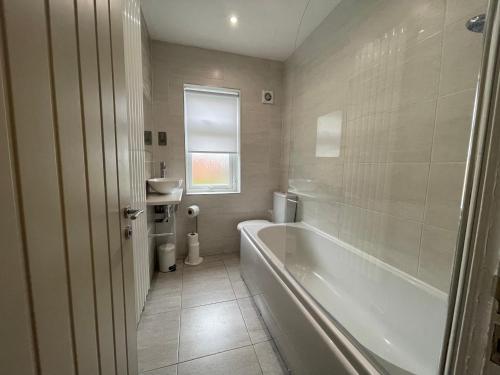 a bathroom with a tub and a toilet and a sink at The Villas holiday homes in Horden