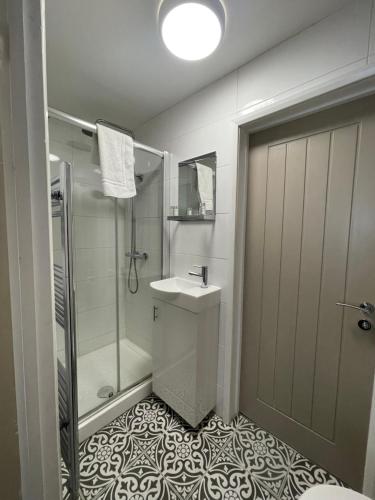 a bathroom with a shower and a sink and a toilet at The Villas holiday homes in Horden