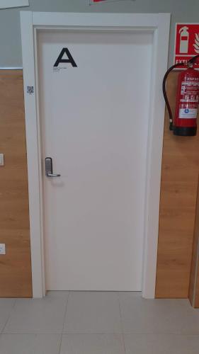 a door that is open to a room with a door at Albergue Turistico la Credencial in Santiago de Compostela