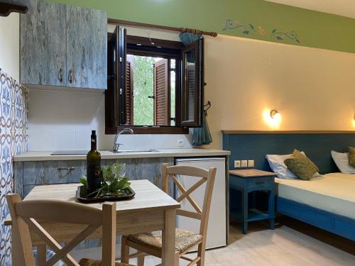 a kitchen and living room with a table and a bed at Harmony resort in Parga