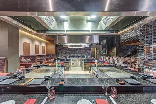 a restaurant with a bar with red tables and chairs at Royalton Hideaway Saint Lucia, An Autograph Collection All-Inclusive Resort - Adults Only in Gros Islet