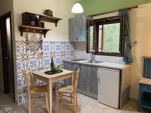 a kitchen with a small table and a sink at Harmony resort in Parga