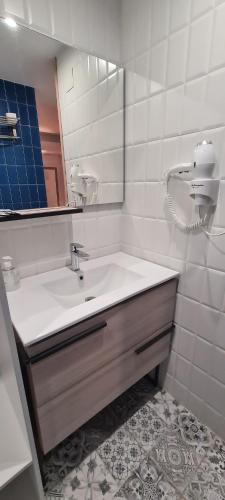 a white bathroom with a sink and a mirror at Posada Maria Santa Pola in Santa Pola