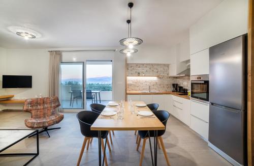 a kitchen and dining room with a table and chairs at Elounda Dream House 2 in Elounda