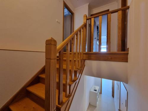 a wooden staircase in a house with a window at Mirador al Cantabrico in Foz
