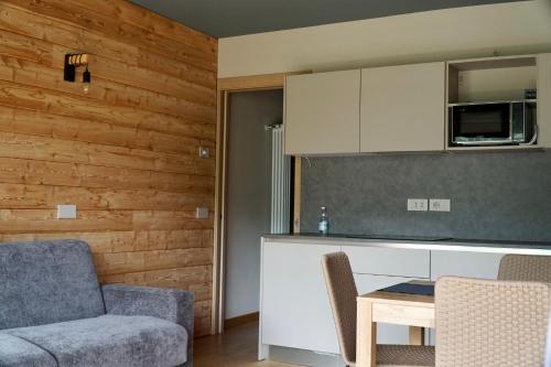 a kitchen with a couch and a table in a room at Alpi Azzurre in Limone Piemonte