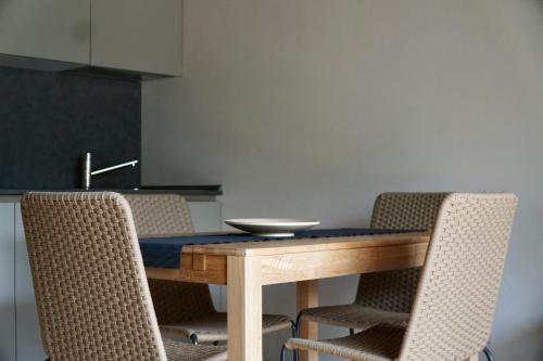 a dining room table with chairs and a bowl on it at Alpi Azzurre in Limone Piemonte