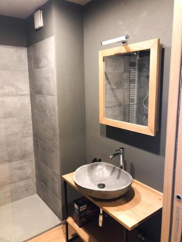 a bathroom with a sink and a mirror and a shower at Alpi Azzurre in Limone Piemonte