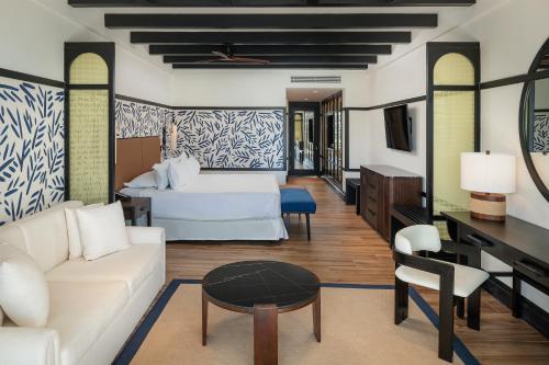 a living room with a couch and a table at Ocean Eden Bay - Adults Only - All Inclusive in Falmouth