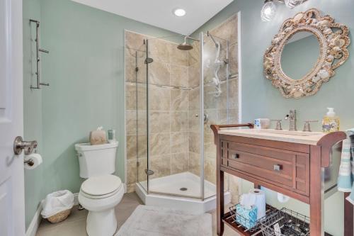 a bathroom with a shower and a toilet and a sink at Saltwater Inn in Belmar