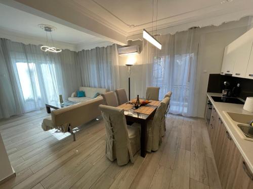 a kitchen and dining room with a table and chairs at Central Number 10 in Néa Péramos