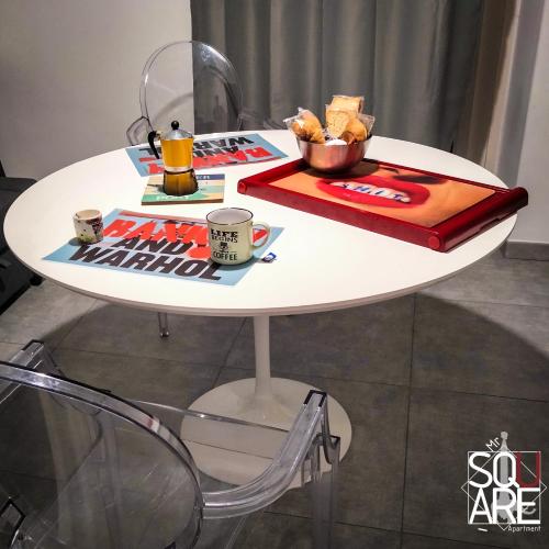 a white table with a tray of food on it at MR SQUARE apartment in Catania