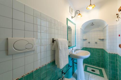 a bathroom with a sink and a mirror at YourHome - Relais Casa degli Angeli in Positano