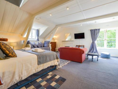a bedroom with a large bed and a chair at Woodlands in Dartmouth
